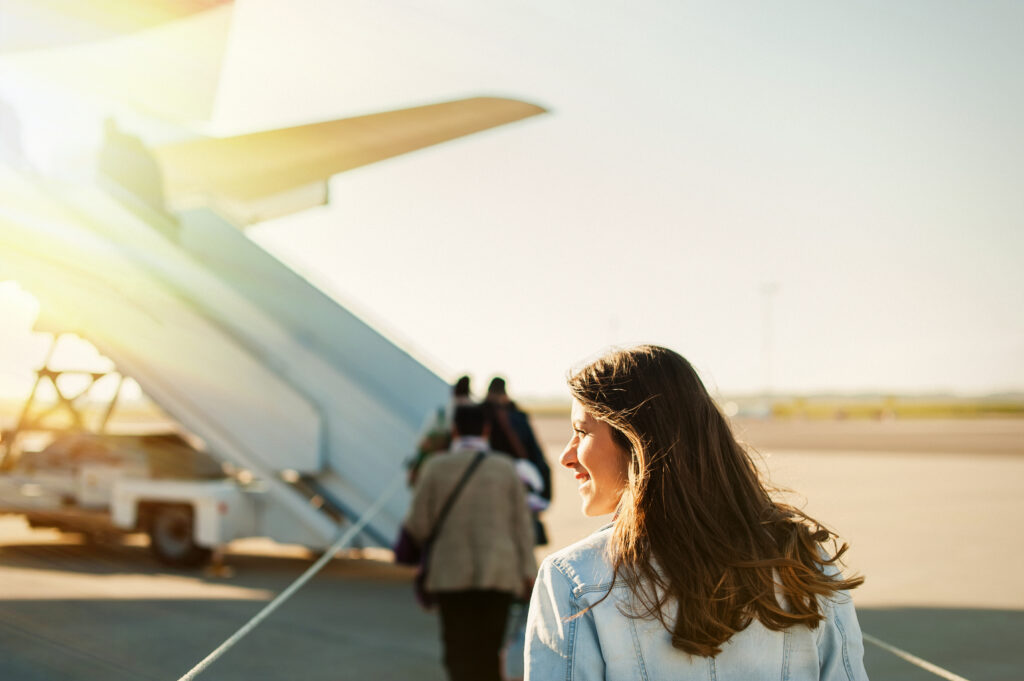 Woman walking towards plane on tarmac