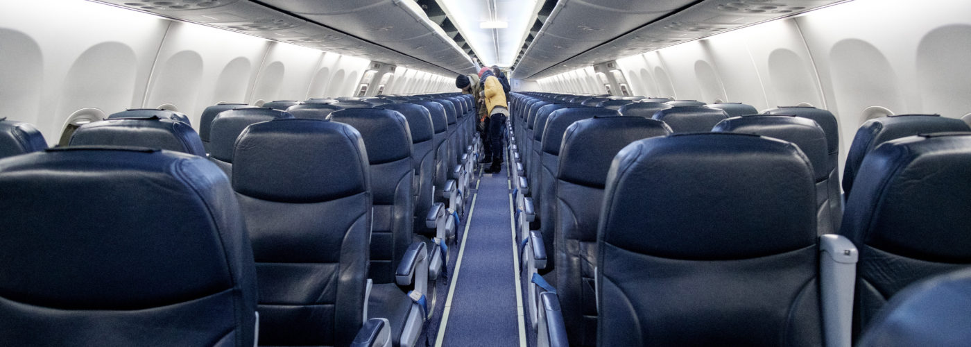 People filing onto empty plane