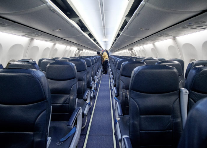 People filing onto empty plane