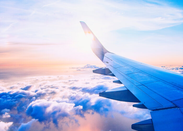 Airplane wing as seen from airplane window mid-flight