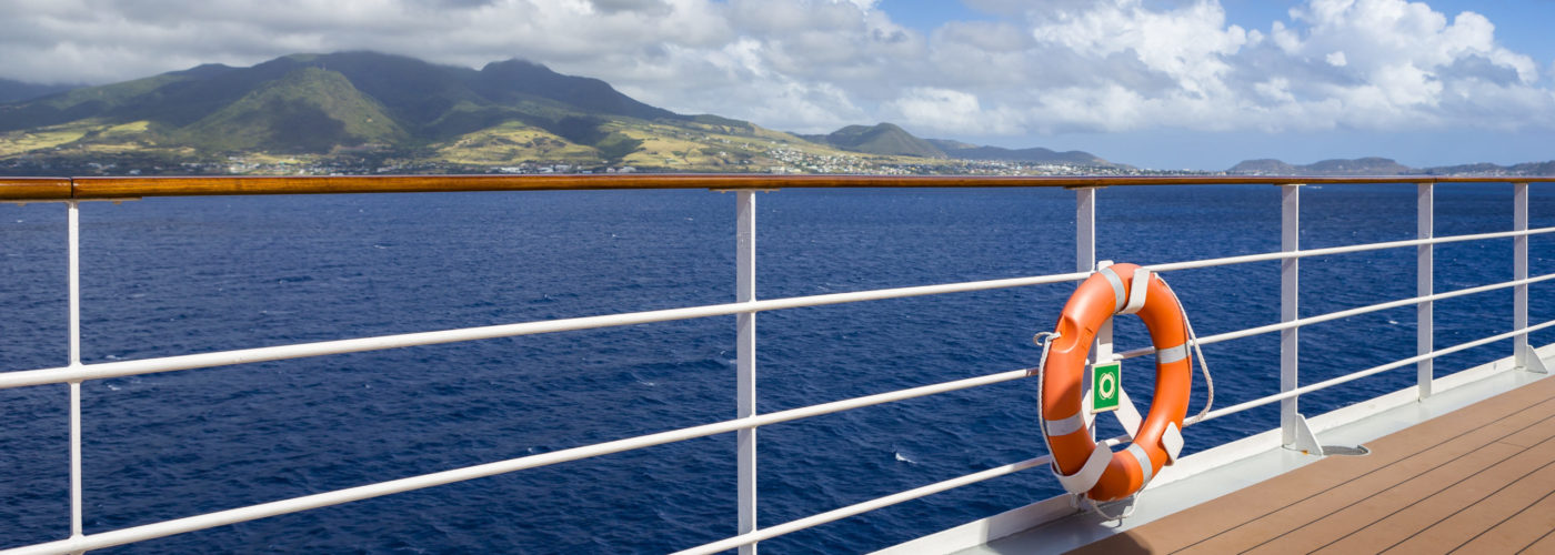 Life preserver hung on the railing on a cruise ship deck