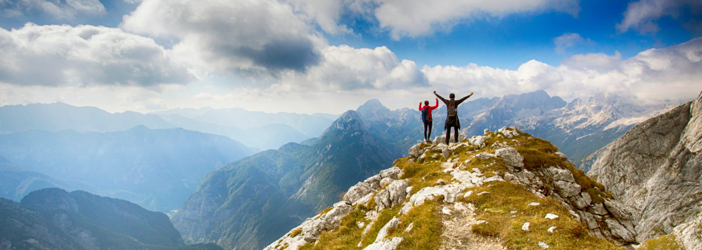 Two people on a peak in the Julian Alps in Slovenia