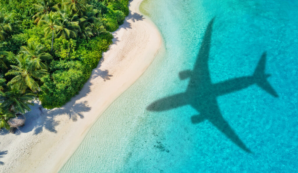 Shadow of large airplane cast over a beach