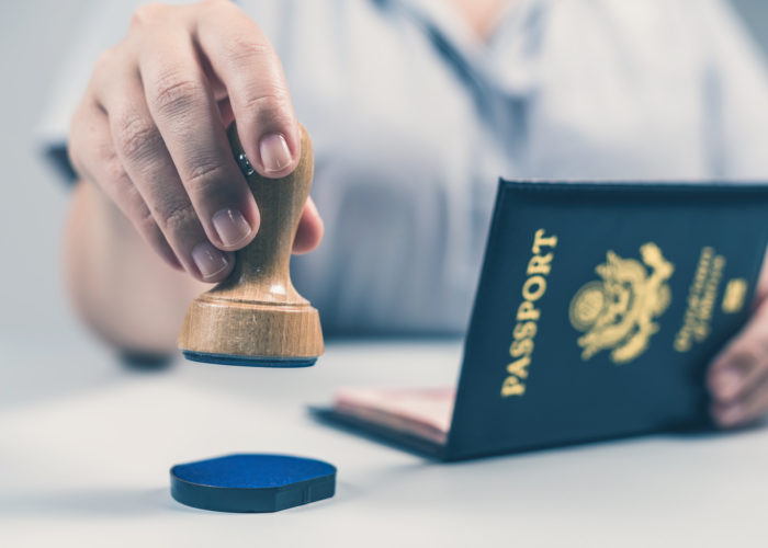 Close up of border security stamping a United States passport