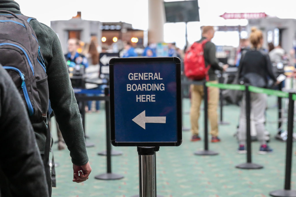 Sign in airport directing people with General Boarding tickets to the left security line