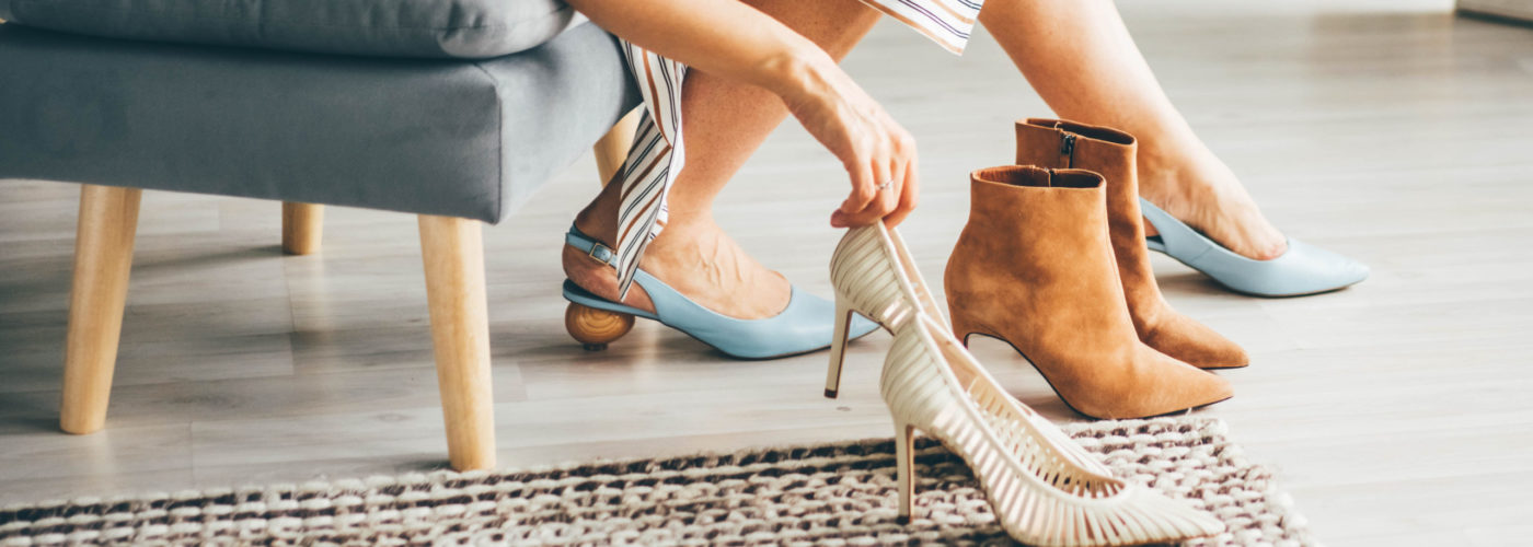 Woman trying on multiple pairs of heeled shoes