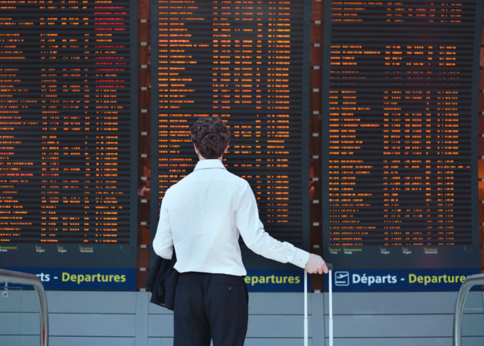 Man looking at departures board at airport