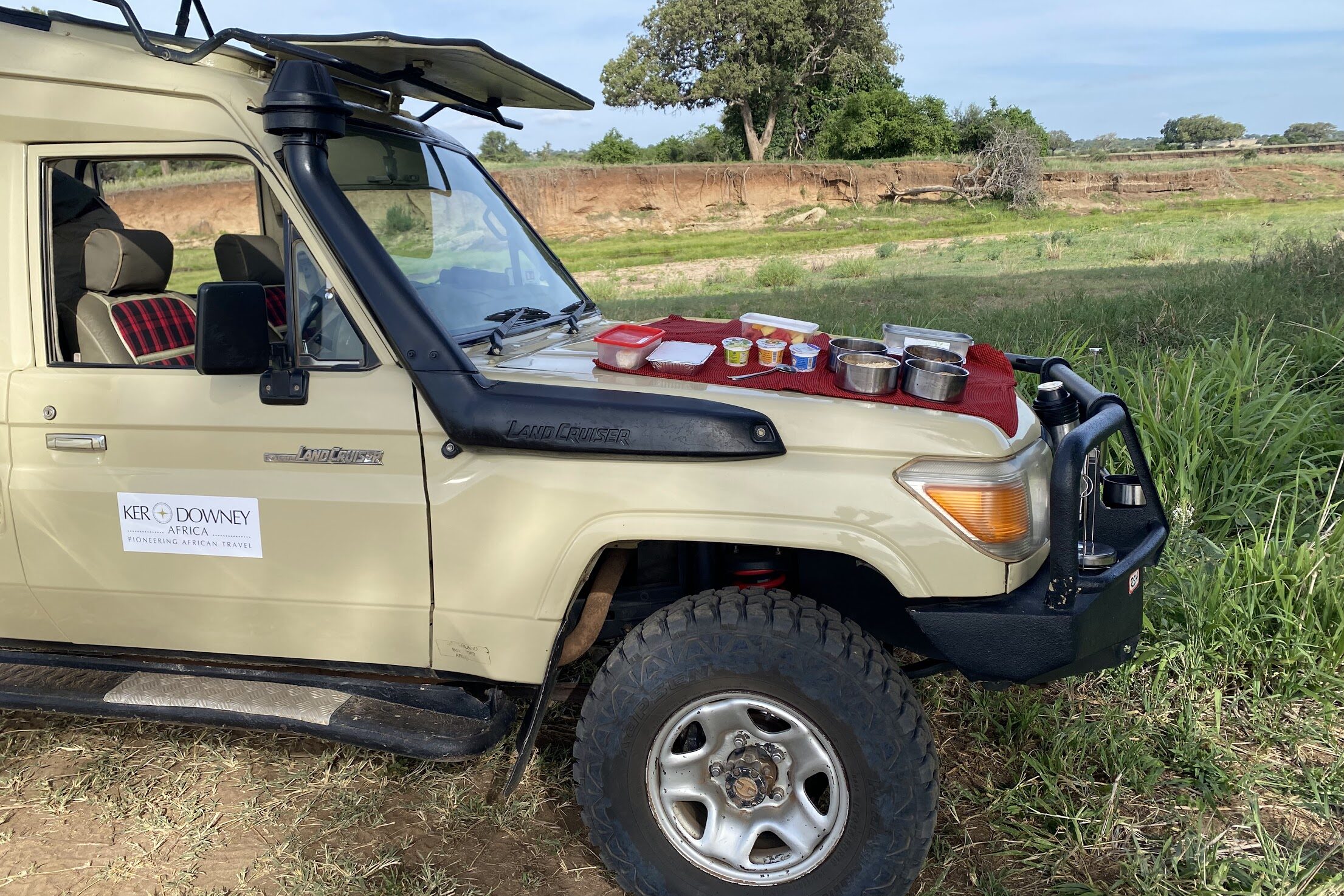 Ker & Downey Africa safari vehicle with afternoon meal laid out on hood