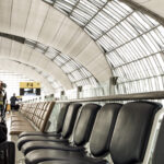 business man with luggage airport seating area