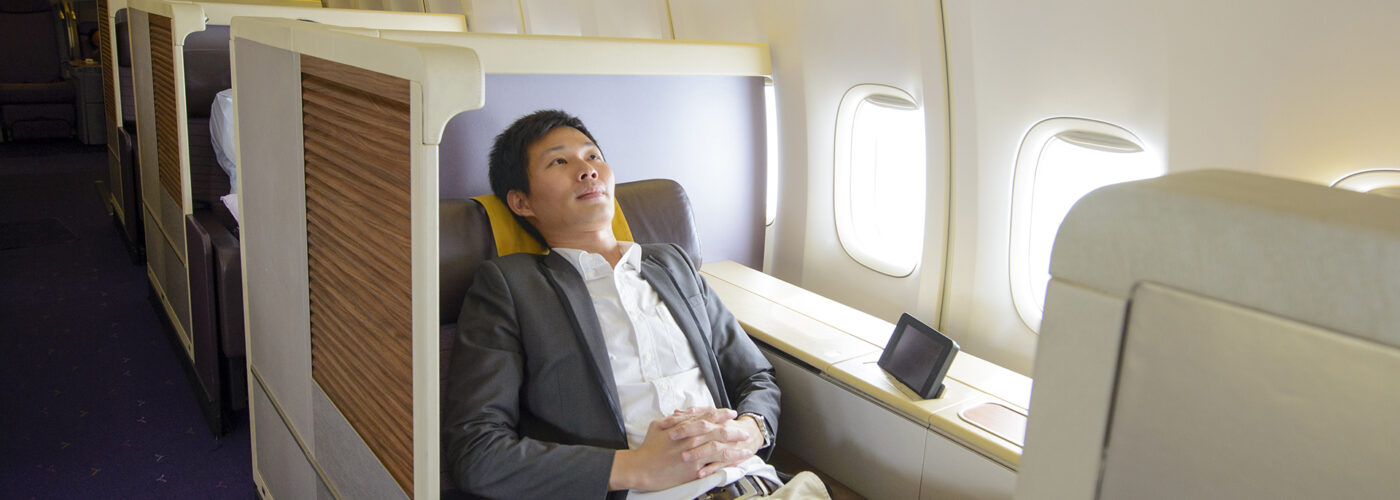 man in first class on airplane.