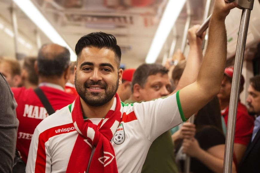 man in sport team shirt on subway.