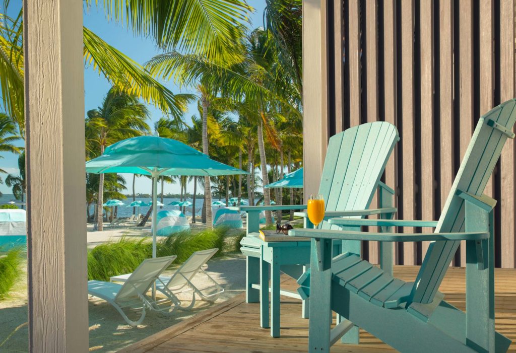 Porch with blue lounge chairs at Bungalows Key Largo in Key Largo, Florida