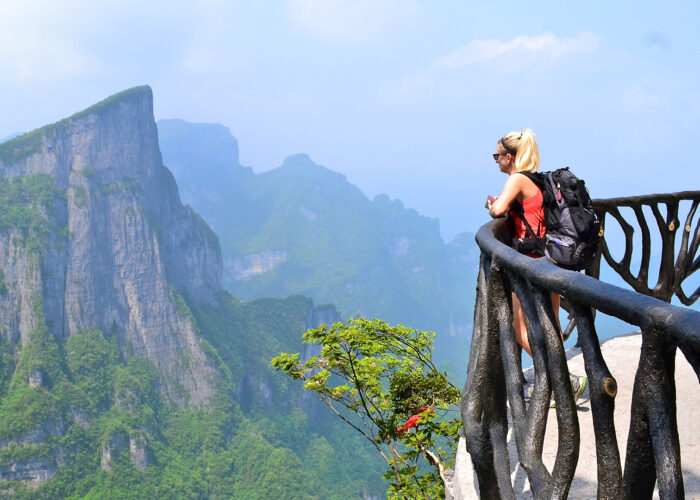 woman looking out over mountain view.