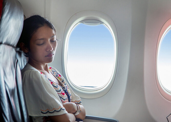 woman sleeping on plane.